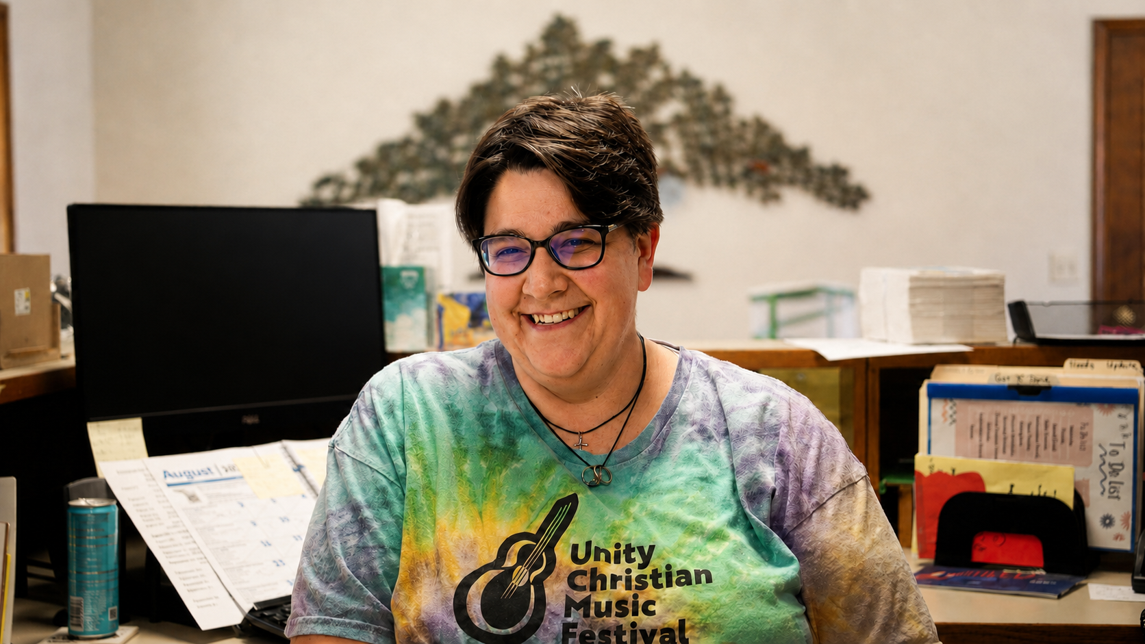 Kelsey Mecher smiling in the church office